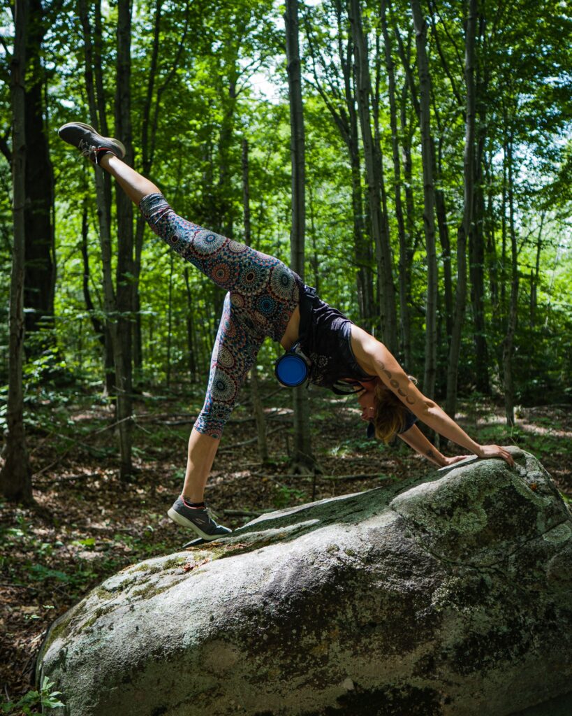 woman doing yoga in the woods