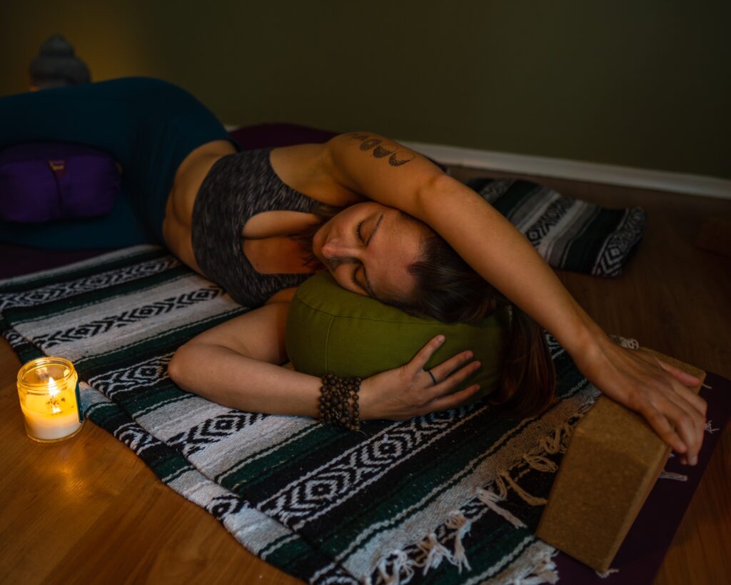 Carole Carter from Living Lotus Online practicing restorative yoga pose