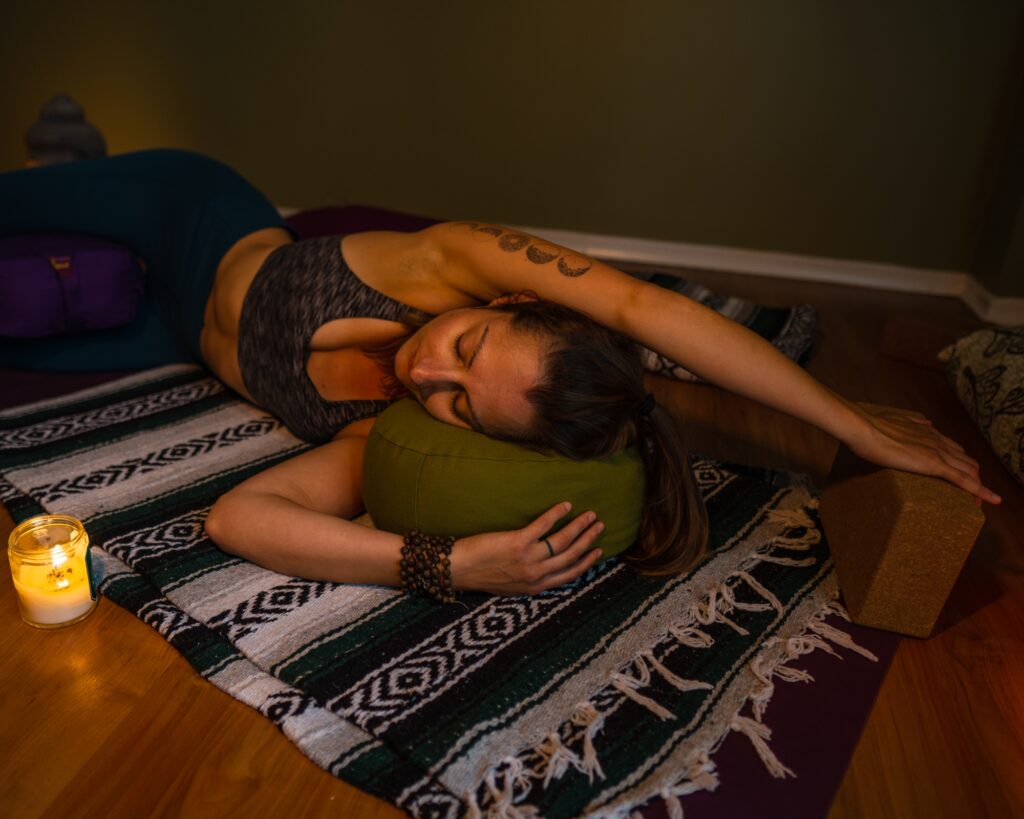Carole Carter from Living Lotus Online practicing restorative yoga pose