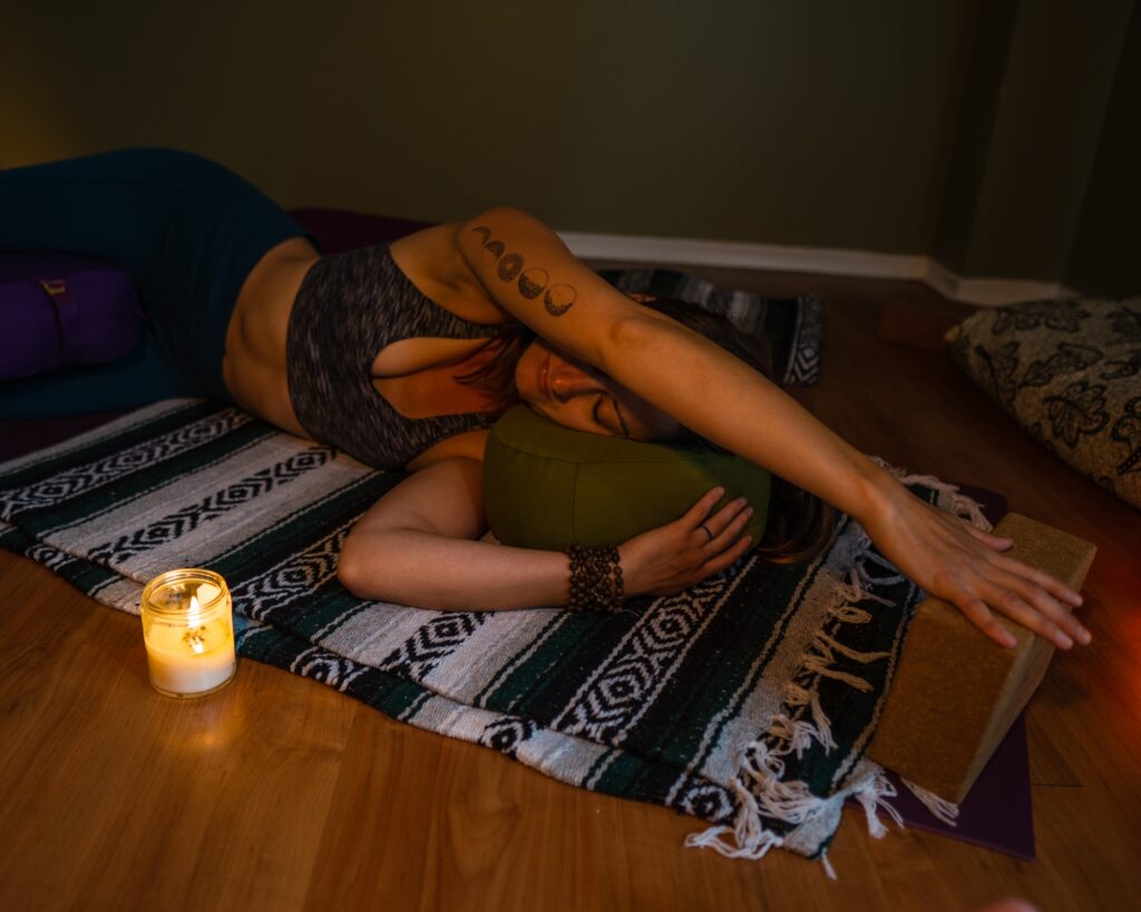 Carole Carter from Living Lotus Online practicing restorative yoga pose