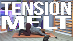 Carole Carter from Living Lotus Online on yoga mat demonstrating extended puppy dog pose Uttana Shishosana Anahatasana