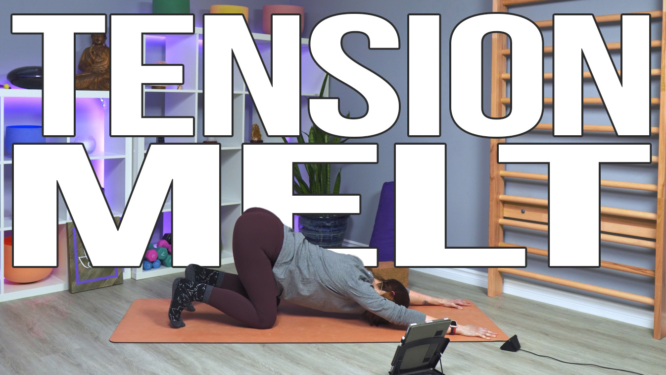 Carole Carter from Living Lotus Online on yoga mat demonstrating extended puppy dog pose Uttana Shishosana Anahatasana