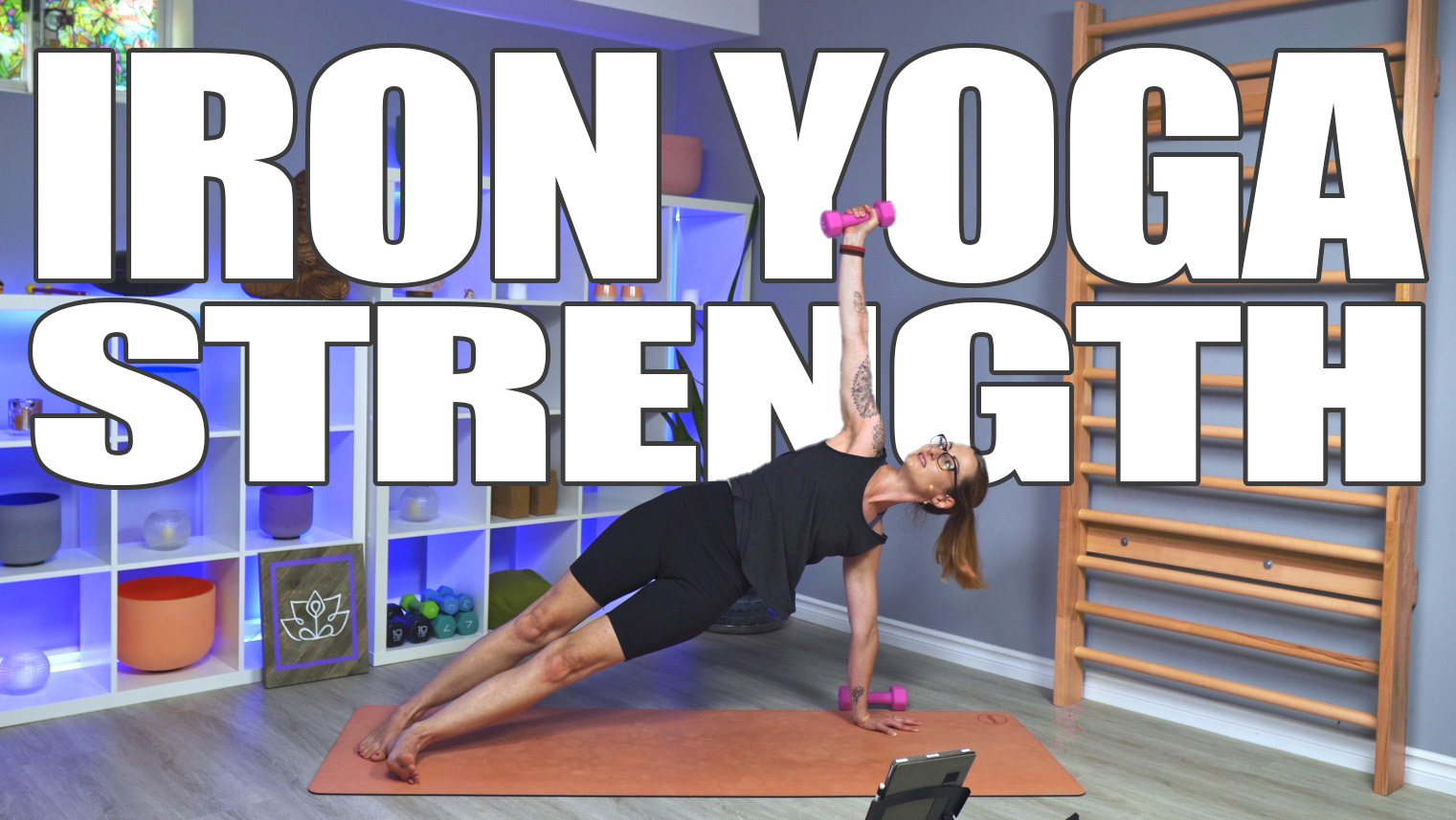 Carole Carter from Living Lotus Online on yoga mat in side plank with weight raised above her head