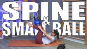 Carole Carter on a yoga mat in Living Lotus Online studio demonstrating movement using the small pilates ball