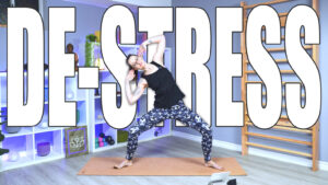 Carole Carter demonstrating Core Flow Yoga to reduce stress in the Living Lotus Online studio